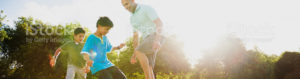 A man and his children playing soccer