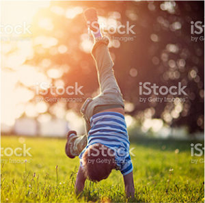 a child playing in grassfield