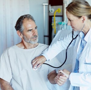 doctor checking patient heart with stethoscope