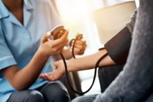 Nurse measuring blood pressure during pre employment physical