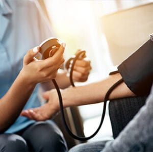 A doctor checking blood pressure