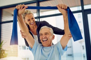A therapist helping old man in exercise