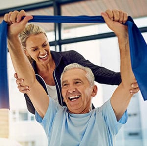 A lady helping man in exercise