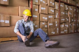 Worker checking his leg injury