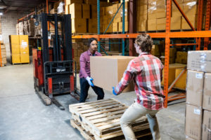 Worker unloading packets from trolley