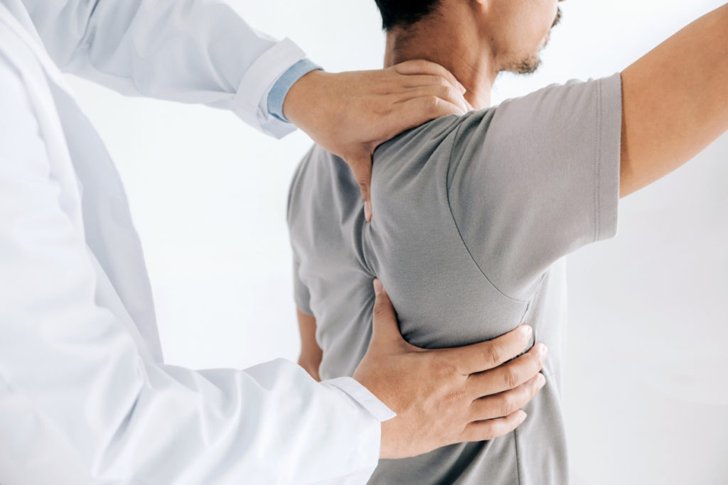 Physiotherapist doing healing treatment on man's back.Back pain patient, treatment, medical doctor, massage therapist.office syndrome