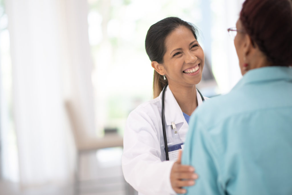 An Elderly Woman in Her Doctors Office Receiving a Check-Up stock photo