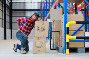 Asian worker man hurt his back "nlift heavy box in factory