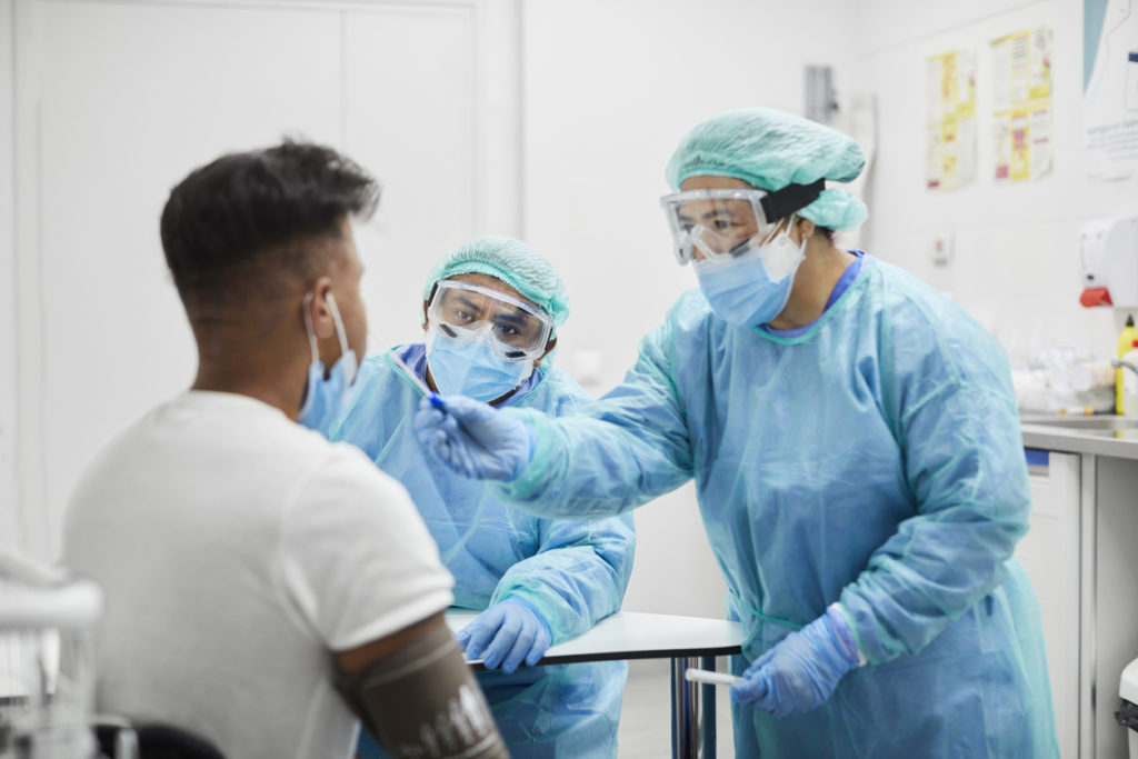 Female Doctor Taking Coronavirus Sample From Man, PCR