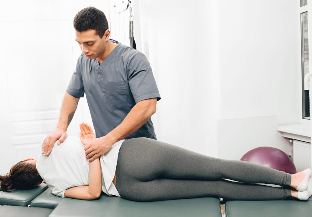 Chiropractor treating patient