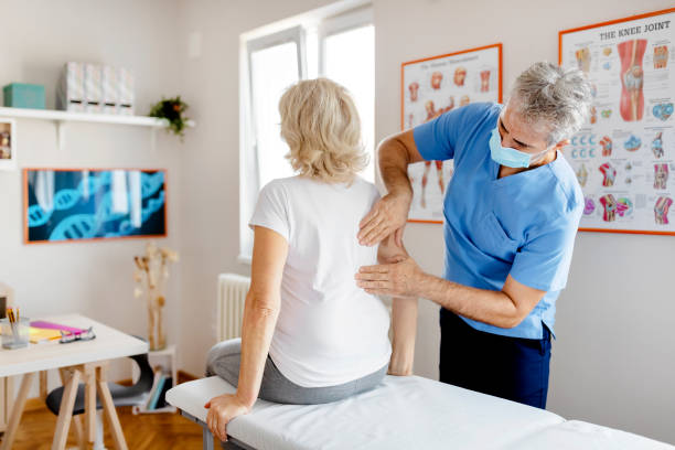 Senior Woman Having Chiropractic Back Adjustment. Osteopathy, Alternative Medicine, Pain Relief Concept. Physiotherapy, Injury Rehabilitation