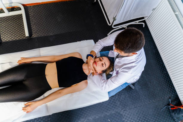 Physiotherapist using chiropractic techniques for neck adjustments