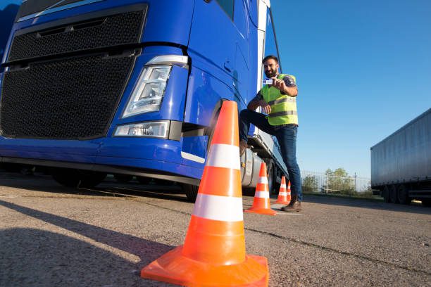 truck driver holding his license after passing DOT physical exam.