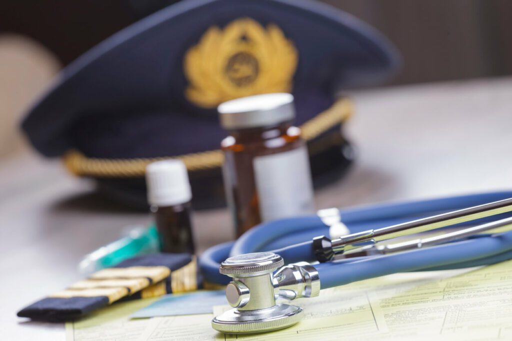 An image showing a pilot's cap and medical equipment to illustrate the FAA medical exam for pilots.