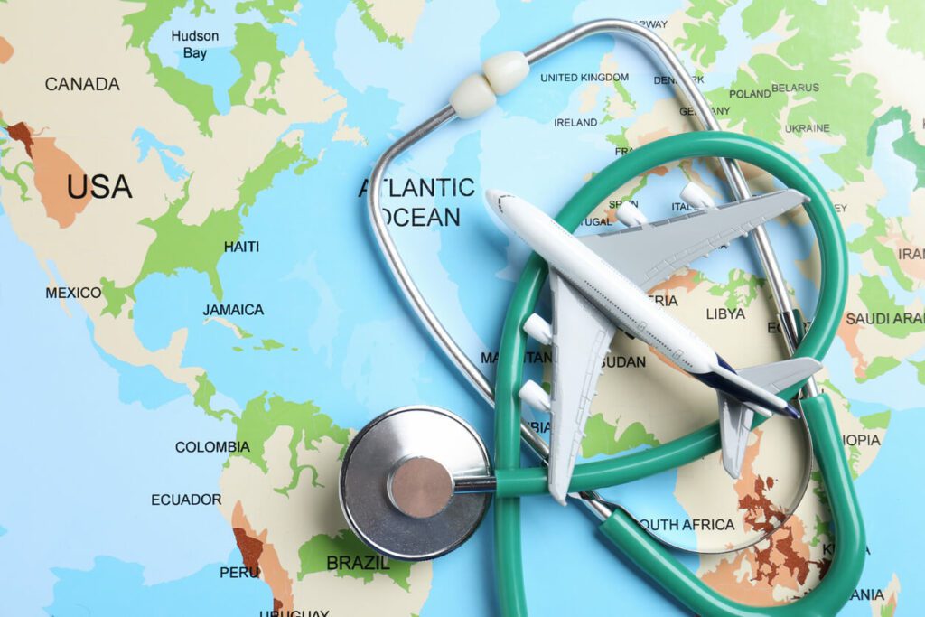 A stethoscope and an airplane model placed on a world map to illustrate the FAA medical exam.
