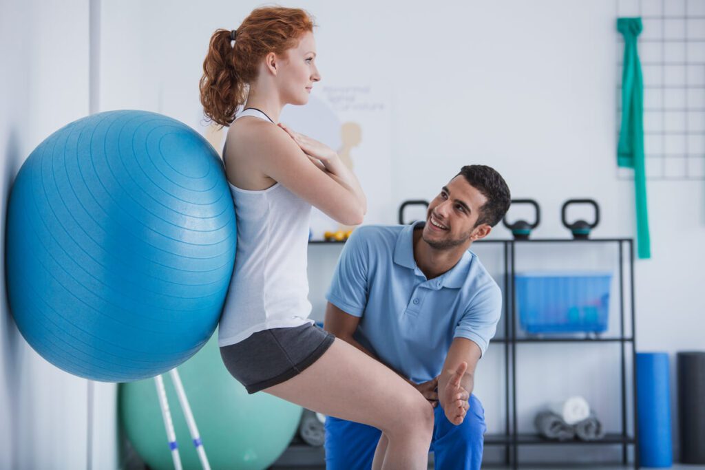 Occupational physical therapist is with a patient with spine injuries.