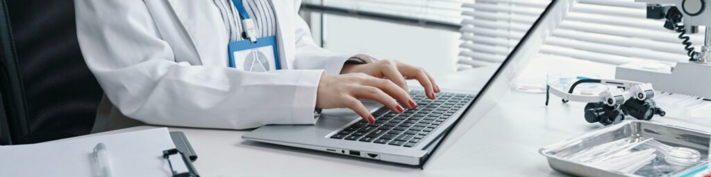 Typing on Laptop in an Occupational Health Clinic.